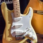 brown and white electric guitar