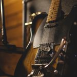 shallow focus photo of black and brown electric guitar