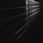 a black and white photo of a guitar