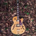 brown and red Epiphone acoustic guitar